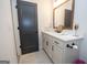 Clean bathroom featuring a white vanity, modern fixtures, and neutral tile flooring at 115 W Wind Ct, Tyrone, GA 30290