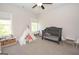Bright, spacious bedroom featuring a crib, tent, and play area, ideal for a room at 115 W Wind Ct, Tyrone, GA 30290
