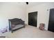 Bedroom with a crib and play area adjacent to dark doors at 115 W Wind Ct, Tyrone, GA 30290