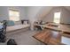 Well-lit bonus room features built-in work space, dormer window, and cozy seating area at 115 W Wind Ct, Tyrone, GA 30290