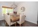 Traditional dining room with wood table, upholstered chairs and natural light at 115 W Wind Ct, Tyrone, GA 30290