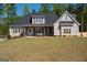 Beautiful home with well-manicured lawn, neutral paint scheme and a cozy front porch at 115 W Wind Ct, Tyrone, GA 30290