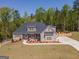 Expansive home exterior with lush lawn, fenced yard, and ample parking for the whole Gathering at 115 W Wind Ct, Tyrone, GA 30290