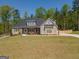 Expansive home exterior with lush lawn, fenced yard, and ample parking at 115 W Wind Ct, Tyrone, GA 30290