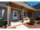 Inviting front porch with wood beam supports and welcoming seating at 115 W Wind Ct, Tyrone, GA 30290
