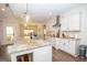 Bright open kitchen with quartz countertops, stainless appliances, and eat in island at 115 W Wind Ct, Tyrone, GA 30290
