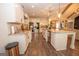 Bright kitchen features stainless appliances, large island and quartz countertops at 115 W Wind Ct, Tyrone, GA 30290