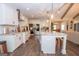 Bright kitchen features stainless appliances, large island and quartz countertops at 115 W Wind Ct, Tyrone, GA 30290