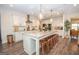 Modern kitchen featuring an expansive island with barstool seating, pendant lighting, and sleek countertops at 115 W Wind Ct, Tyrone, GA 30290