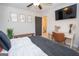 Bedroom featuring an open ensuite bathroom, a desk, and decor at 115 W Wind Ct, Tyrone, GA 30290