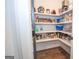 Organized walk-in pantry featuring wooden floors and well-stocked shelving space for optimal storage at 115 W Wind Ct, Tyrone, GA 30290