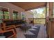 Inviting porch features comfortable seating and views of the natural wooded surroundings at 115 W Wind Ct, Tyrone, GA 30290