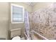 This bathroom features linoleum tiles, a shower and tub combo, and a window at 324 County Line Rd, Fayetteville, GA 30215