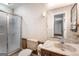 Bathroom vanity with a marble countertop, an enclosed shower, and patterned wallpaper at 324 County Line Rd, Fayetteville, GA 30215