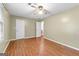 This is a bedroom that includes wood floors, a ceiling fan, and access to the hallway at 324 County Line Rd, Fayetteville, GA 30215