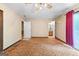 A vintage carpeted bedroom shows access to the hallway and has large glass doors at 324 County Line Rd, Fayetteville, GA 30215