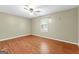 A bedroom is painted with neutral colors and showcases the beautiful hardwood floors at 324 County Line Rd, Fayetteville, GA 30215