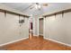 A bedroom displays modern hardwood floors, neutral painted walls, and a ceiling fan at 324 County Line Rd, Fayetteville, GA 30215