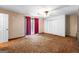 This bedroom has vintage carpet, a fan, large closet, and glass doors to the outside at 324 County Line Rd, Fayetteville, GA 30215