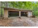 Outdoor garage with two bays and block construction nestled among trees at 324 County Line Rd, Fayetteville, GA 30215