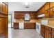 Well-lit kitchen boasts classic wood cabinets, white appliances, and practical countertops with a view of the yard at 324 County Line Rd, Fayetteville, GA 30215