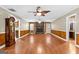 Spacious living room features hardwood floors, a stone fireplace, wood-paneled walls, and natural light at 324 County Line Rd, Fayetteville, GA 30215