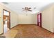 Living room with patterned wallpaper, unique carpeting, a ceiling fan, and a window with red curtains at 324 County Line Rd, Fayetteville, GA 30215