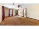 View of the living room showing a door to the backyard, patterned wallpaper, and a ceiling fan at 324 County Line Rd, Fayetteville, GA 30215
