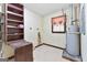 Utility room with water heater, storage shelves, a small window, and tile flooring at 324 County Line Rd, Fayetteville, GA 30215