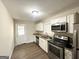 Modern kitchen with stainless steel appliances, granite countertops, and ample cabinet space at 2155 Meador Se Ave, Atlanta, GA 30315