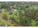 A bird's eye view of a rural property surrounded by lush trees and a long driveway at 24 Shiloh Church Rd, Carrollton, GA 30116