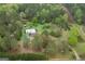 An aerial perspective of a home site with mature trees, outbuildings and a winding driveway at 24 Shiloh Church Rd, Carrollton, GA 30116