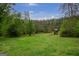 Spacious backyard offers plenty of room for recreation and relaxation amidst mature trees at 24 Shiloh Church Rd, Carrollton, GA 30116