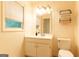 This bright bathroom offers a vanity and toilet, illuminated by natural light from the window at 24 Shiloh Church Rd, Carrollton, GA 30116