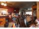 Cluttered kitchen with red cabinets, a tin ceiling, and an adjacent dining area in disarray at 24 Shiloh Church Rd, Carrollton, GA 30116