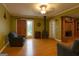 Inviting living room with wood-burning stove, hardwood floors, and a brick fireplace, exuding warmth and character at 24 Shiloh Church Rd, Carrollton, GA 30116