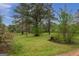 Expansive yard with mature trees, shrubs, and greenery at 24 Shiloh Church Rd, Carrollton, GA 30116