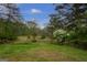 Picturesque yard features mature trees, flowering shrubs, and a winding driveway at 24 Shiloh Church Rd, Carrollton, GA 30116
