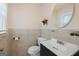 Traditional half-bathroom with round mirror and custom dark vanity at 9155 Lakeview Sw Dr, Covington, GA 30014