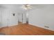 Bedroom with hardwood floors, ceiling fan and closet with mirrored doors at 9155 Lakeview Sw Dr, Covington, GA 30014