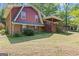Charming home featuring a brick foundation, red siding, and a covered porch for outdoor enjoyment at 9155 Lakeview Sw Dr, Covington, GA 30014