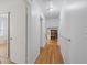 Hallway with hardwood flooring provides an unobstructed path from the bedrooms to the main living area at 9155 Lakeview Sw Dr, Covington, GA 30014