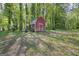 Red barn-style shed, perfect for storage or as a workshop for hobbies at 9155 Lakeview Sw Dr, Covington, GA 30014