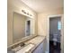 Bathroom features a vanity with a granite countertop, framed mirror, and modern lighting at 825 Rapid Ct, Mcdonough, GA 30252