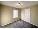 Cozy bedroom with neutral walls, plush carpeting, and a window with lots of natural light at 825 Rapid Ct, Mcdonough, GA 30252