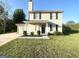 Traditional home featuring neutral siding, black shutters, and tidy landscaping at 825 Rapid Ct, Mcdonough, GA 30252