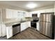 Updated kitchen featuring stainless steel appliances and white cabinetry at 825 Rapid Ct, Mcdonough, GA 30252