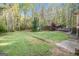 Large backyard with a wooded area, wooden deck and partially enclosed wooden gazebo at 215 North Mourning Dove N Dr, Fayetteville, GA 30215
