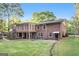 Spacious backyard featuring a brick house with a screened-in porch and a well-maintained lawn at 215 North Mourning Dove N Dr, Fayetteville, GA 30215