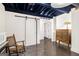 Finished basement with exposed ceiling, painted floors, barn door, and vintage furniture at 215 North Mourning Dove N Dr, Fayetteville, GA 30215